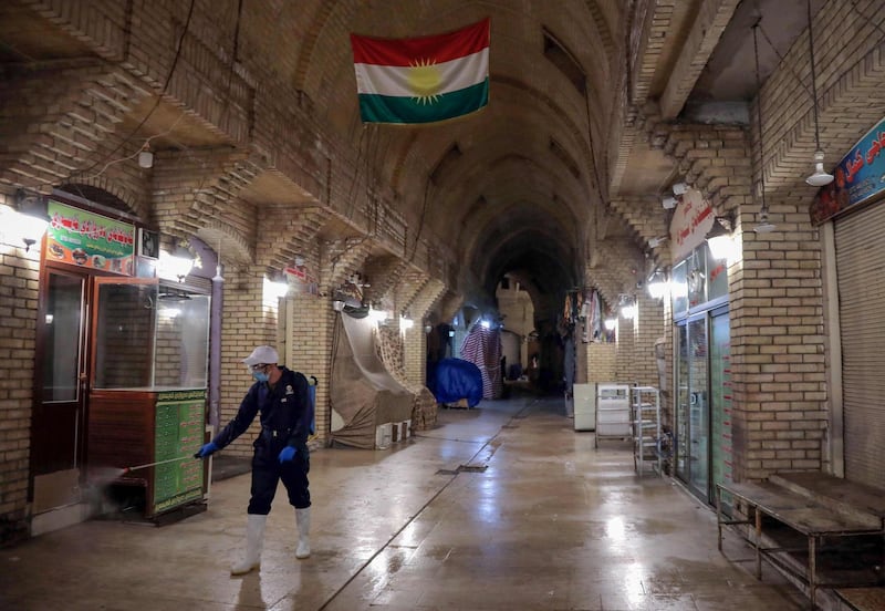 A municipal worker sprays disinfectant in the old market in Erbil, the capital of the northern Iraqi Kurdish autonomous region, as a precautionary measure against the spread of the novel coronavirus.  AFP