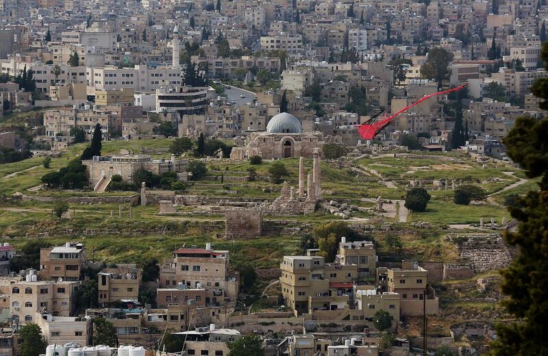 TOPSHOT - A picture taken on April 27, 2020, shows a kite flying over the Jordanian capital Amman, with the Amman Citadel in the background.   / AFP / Khalil MAZRAAWI
