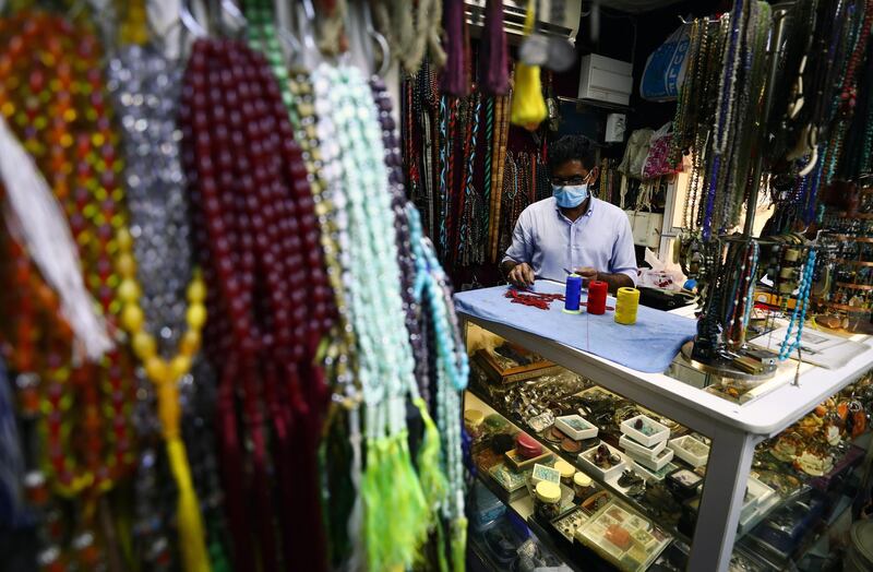A man makes prayer beads in his shop at Central Souq in Sharjah. Getty
