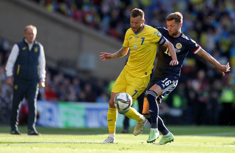 Ukraine's Andriy Yarmolenko, left, duels for the ball with Scotland's Liam Cooper. AP Photo