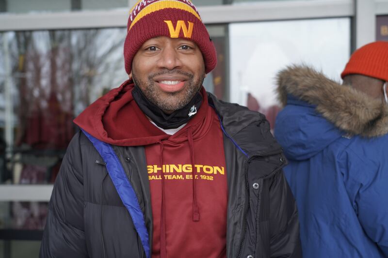 Nate Scarlett waited outside for three hours in freezing temperatures to be one of the first to buy Washington Commanders apparel. Willy Lowry / The National.