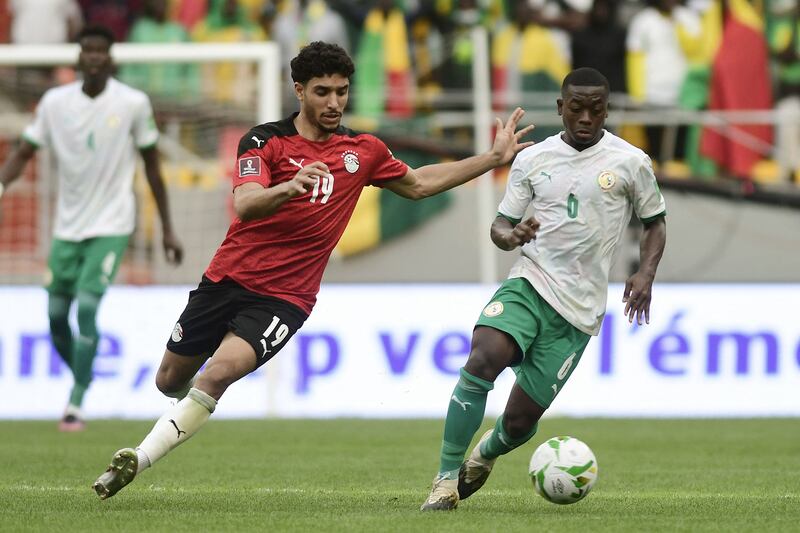 Senegal's Nampalys Mendy under pressure from Omar Marmoush of Egypt. AFP