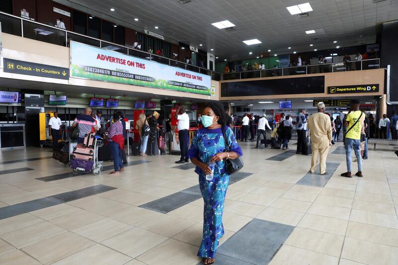 A woman wears a protective face mask at the Murtala Mohammed International airport in Lagos, Nigeria, in March. Temilade Adelaja / Reuters