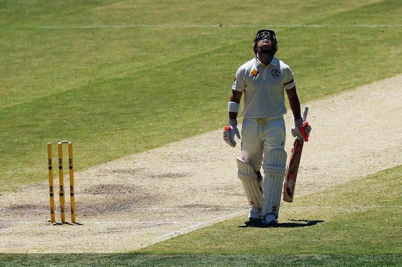 David Warner of Australia looks up to the sky in tribute to the late Phillip Hughes after making his half century during day four of the First Test match between Australia and India at Adelaide Oval on December 12, 2014 in Adelaide. Michael Dodge/Getty Images