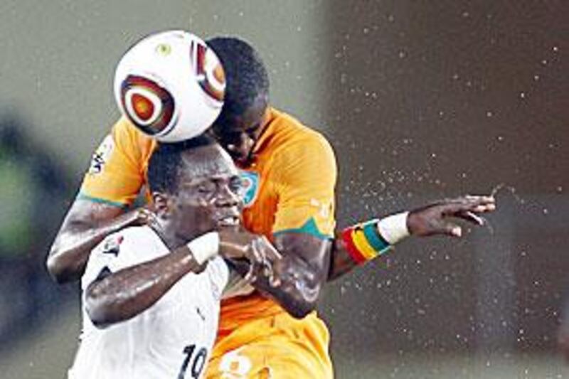 Ivory Coast's Yaya Toure, right, wins the aerial duel for the ball from Ghana's Emmanuel Agyemang-Badu in Cabinda.
