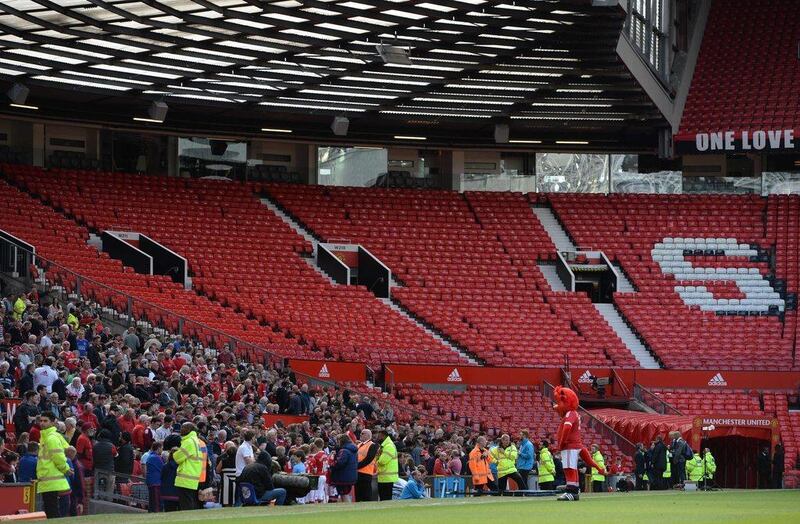 The Stretford End is pictured empty following the evacuation of both the Sir Alex Ferguson stand (unseen) and the Stretford stands ahead of the Premier League match between Manchester United and Bournemouth at Old Trafford in Manchester, north west England, on May 15, 2016. Oli Scarff / AFP
