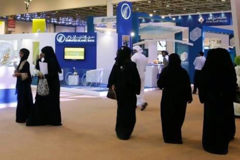 Emirati job fairs, as seen above in Sharjah, are among measures that can help to draw more women into the UAE workforce. Jeffrey E Biteng / The National