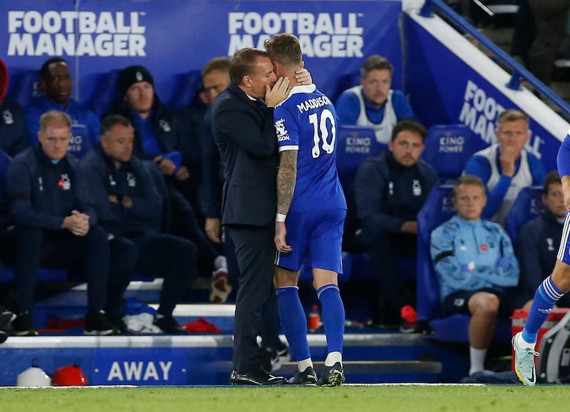 Leicester City manager Brendan Rodgers embraces James Maddison after the midfielder is substituted. Reuters