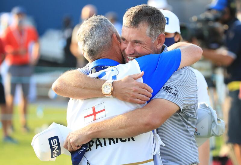 Billy Foster, caddie for Matthew Fitzpatrick, embraces Lee Westwood for winning the race to Dubai. Getty