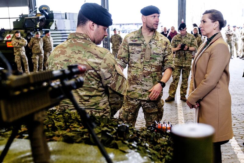 Danish Prime Minister Mette Frederiksen speaks with military officers during a visit to the island of Bornholm. EPA