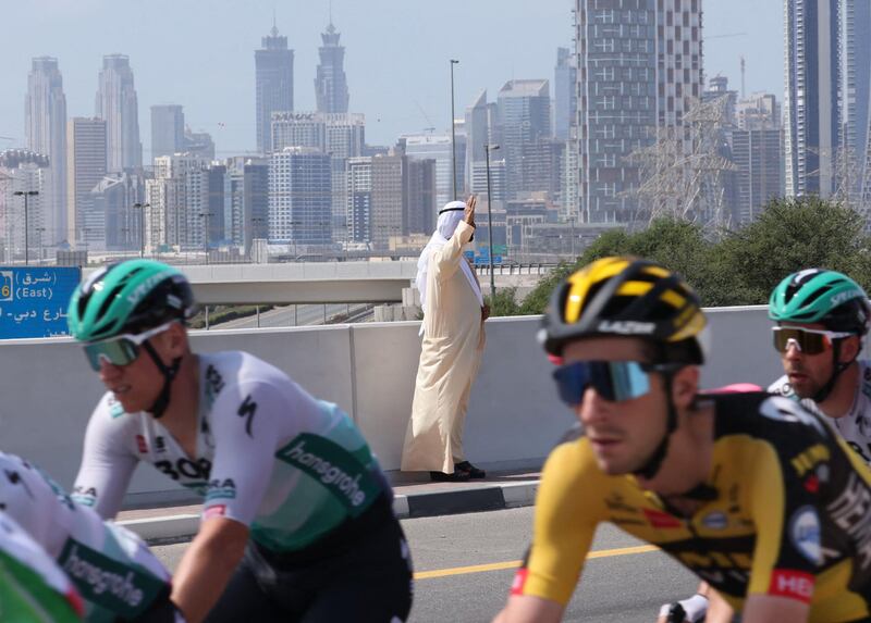 Sheikh Mohammed bin Rashid waves as riders take part in the sixth stage of the UAE Tour from  Deira Islands to Palm Jumeriah. AFP