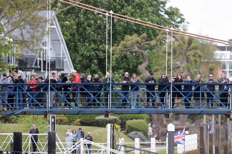 People on a bridge over the Thames trying to see the whale swimming past. Reuters