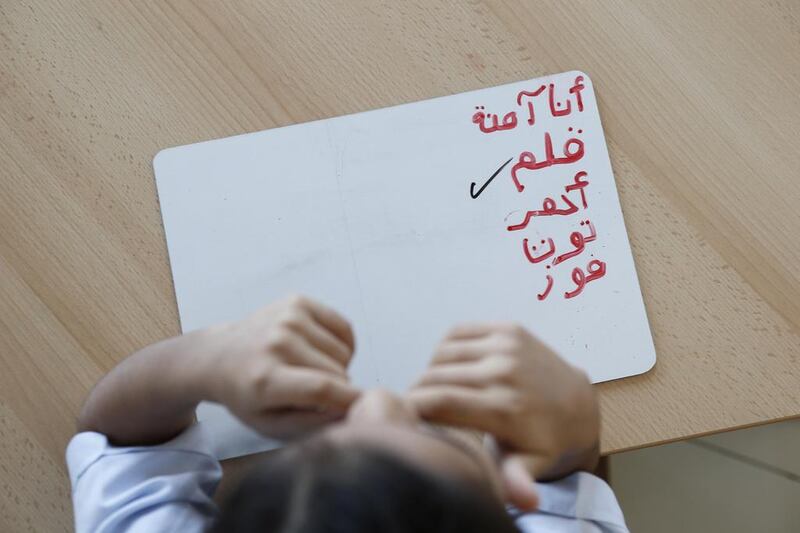 A child learning to write in Arabic. (Photo: Antonie Robertson/The National) 