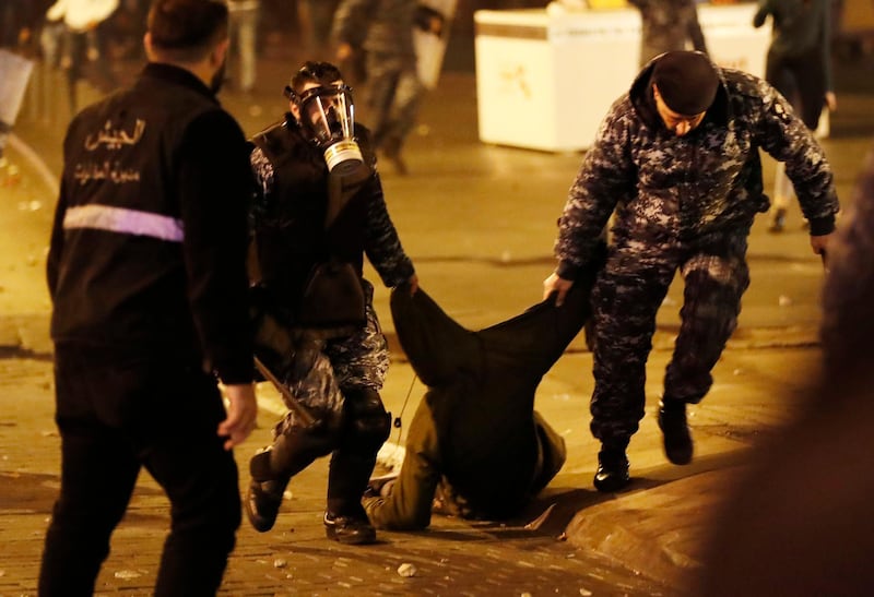 Riot police officers arrest an anti-government protesters trying to enter parliament square in downtown Beirut. AP