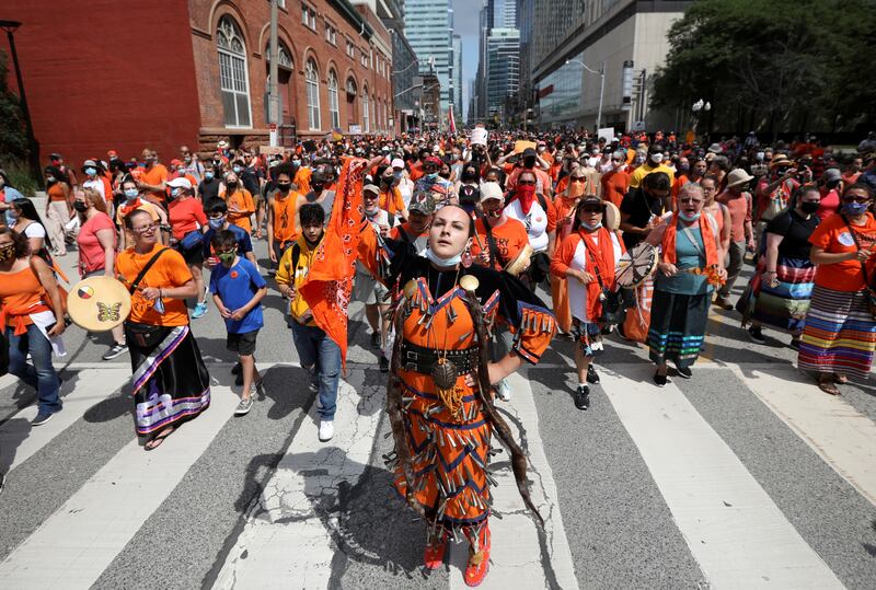 Marchers perform a healing dance during a march after the discovery of hundreds of remains of children at former indigenous residential schools, on Canada Day in Toronto. Reuters