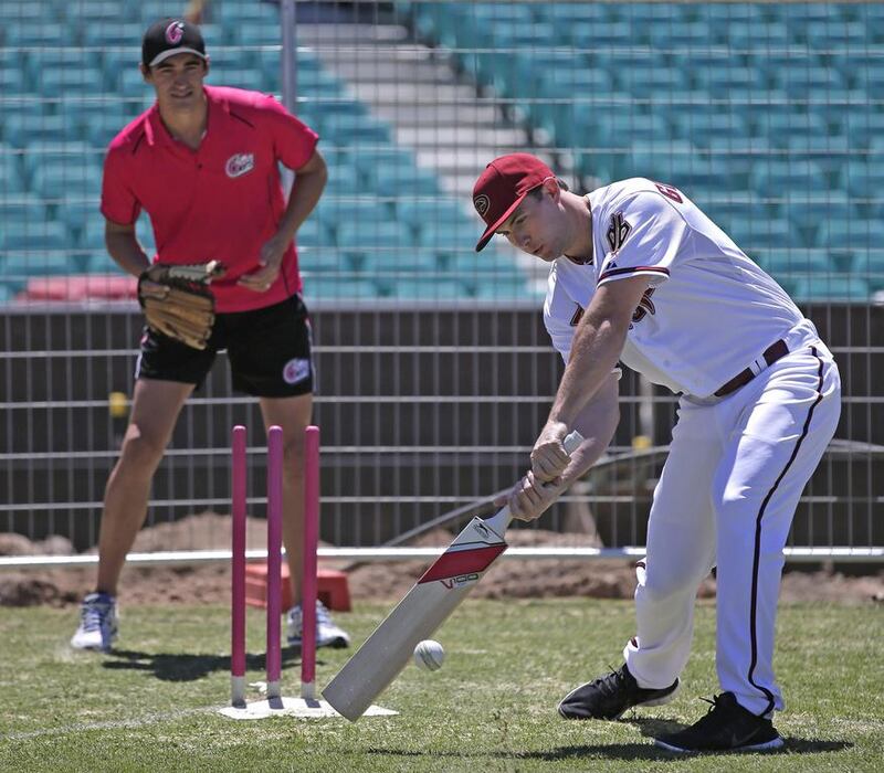 In this November 4, 2013, file photo, Arizona Diamondbacks first baseman Paul Goldschmidt, right, uses a cricket bat to hit a ball at the Sydney Cricket Ground in Sydney, as Australian cricket player Mitchell Starc fields behind. An Australian all-star team will face MLB clubs in exhibition games against the Los Angeles Dodgers) and the Diamondbacks ahead of the regular-season games on March 22 and 23 at the Sydney Cricket Ground. Rick Rycroft / AP Photo