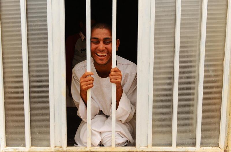 An Afghan patient smiles as he looks out of a window from a room inside the rehabilitation centre.