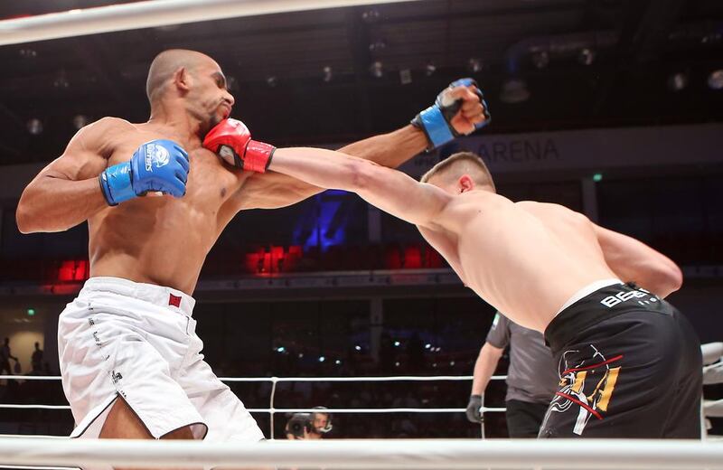 The UAE’s Ahmad Al Darmaki, in white shorts, fights with Artiyom Gorodynets from Ukraine in the Abu Dhabi Warriors 4 at IPIC Arena in Zayed Sports city in Abu Dhabi. Ravindranath K / The National