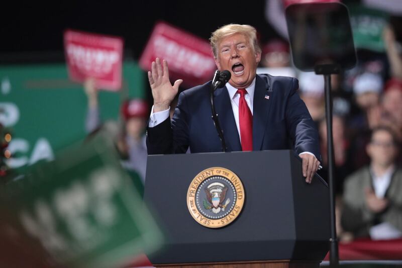 President Donald Trump speaks at his Merry Christmas Rally at the Kellogg Arena on December 18, 2019 in Battle Creek, Michigan. While Trump spoke at the rally the House of Representatives voted, mostly along party lines, to impeach the president for abuse of power and obstruction of Congress. Getty Images/AFP