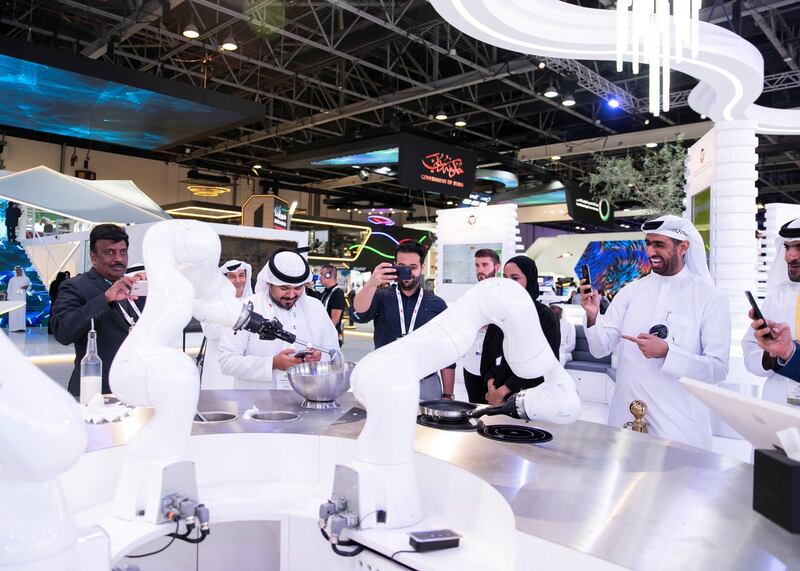 DUBAI, UNITED ARAB EMIRATES. 06 OCTOBER 2019. 
People take photos of a robot preparing a crepe during Gitex Technology Week at Dubai World Trade Center.

(Photo: Reem Mohammed/The National)

Reporter:
Section: