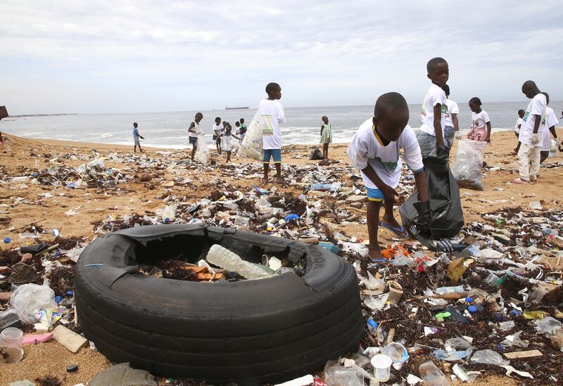 Members of an environmental NGO clean up plastic debris on Vridi beach, a popular tourist destination in the city of Abidjan, Ivory Coast, a day before World Environment Day.  EPA 