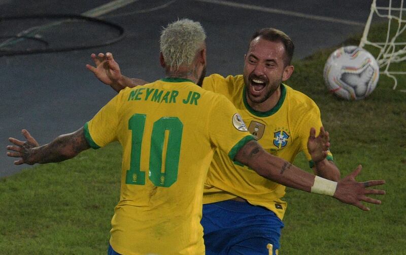 Brazil's Everton Ribeiro celebrates with teammate Neymar after scoring against Peru. AFP