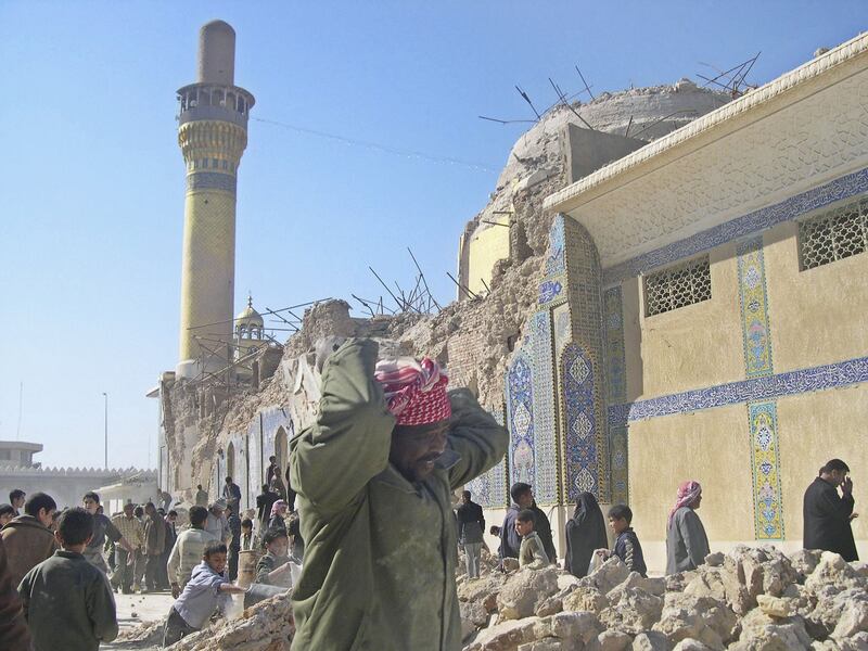 February 23, 2006: Iraqis clean up debris after an Al Qaeda bombing at Al Askariya holy Shiite shrine in Samarra, Iraq. Shiite police and militia members — in many cases indistinguishable — responded by rampaging through Sunni-majority areas, in an onslaught that coalition forces appeared powerless to halt. Getty