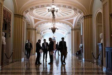 Congressional staffers wait in the corridor outside the Senate chamber during a delay in work on the Democrats' $1.9 trillion Covid-19 relief bill at the Capitol in Washington, March 5, 2021. AP