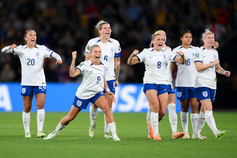 England's players celebrate after Chloe Kelly scored the winning penalty. Getty