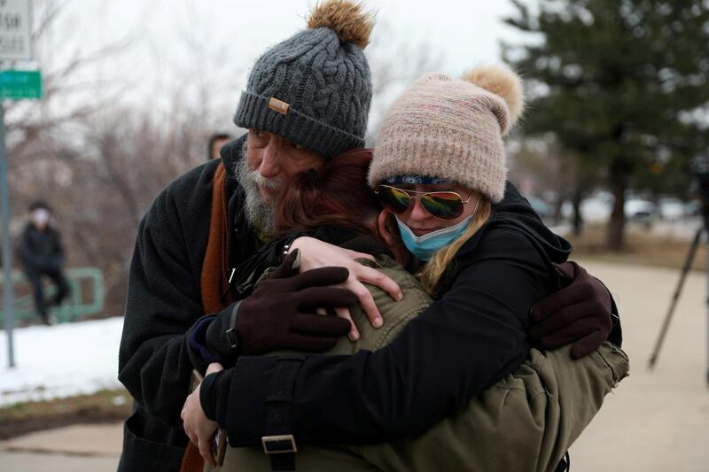 Sarah Moonshadow is comforted by David and Maggie Prowell after Moonshadow was inside King Soopers grocery store during the shooting. Reuters