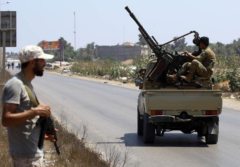 Libyans security forces patrol on August 23, 2018 near the site of an attack on a checkpoint in the city of Zliten, 170 km east of the capital Tripoli. - An attack on a checkpoint between the Libyan capital and the town of Zliten killed four soldiers of the UN-backed unity government on today, the town's mayor said. (Photo by Mahmud TURKIA / AFP)