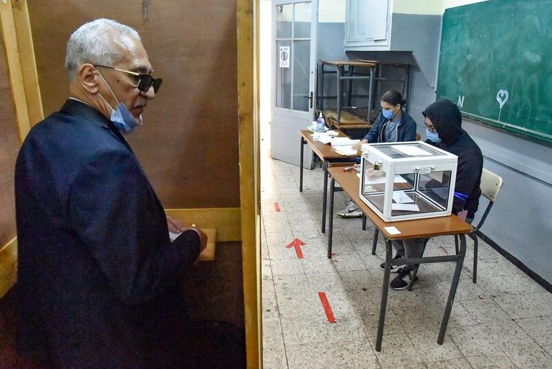 An Algerian man prepares to vote at a polling station in the capital Algiers during a vote for a revised constitution. AFP
