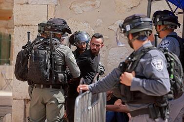 Israeli security forces detain a man at the entrance of Jerusalem's Al Aqsa mosque compound on May 21. AFP