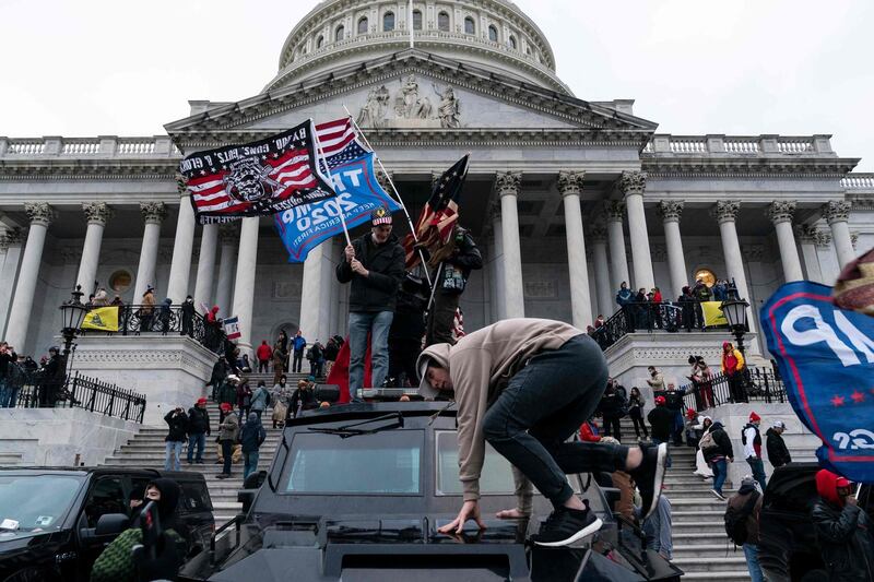 (FILES) In this file photo taken on January 6, 2021, supporters of US President Donald Trump protest outside the US Capitol in Washington, DC. A day after the Senate acquitted Donald Trump in a historic second impeachment trial, America was weighing how long a shadow the former president, even with a tarnished legacy, will continue to cast -- over his party, and over the country. As much of the world watched, the Senate on February 13, 2021 voted 57-43 to convict Trump of inciting the January 6 assault on the US Capitol. It was a stinging rebuke, with seven Republicans joining all Democrats in the most bipartisan impeachment vote ever, but it fell short of the 67 votes needed for conviction.  
 / AFP / ALEX EDELMAN
