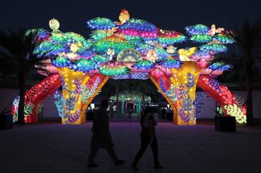 DUBAI, UNITED ARAB EMIRATES , October 14 – 2020 :- View of the colourful light figures at the Dubai Garden Glow season 6 which opened on 12th October at the Zabeel park in Dubai. No sitting allowed on the benches as a precautionary measure against the spread of coronavirus. Security at the entrance gate checks the body temperature of all the visitors. (Pawan Singh / The National) For Life Style/Online/Instagram/Big Picture. Story by Evelyn Lau