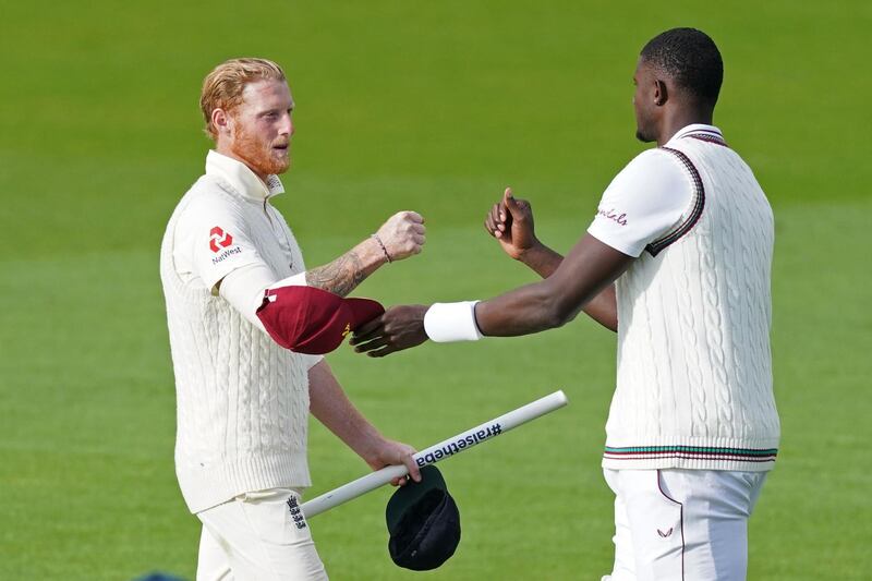 England's Ben Stokes, left, with West Indies' Jason Holder after England wrap up the Test on the final day in Manchester. AFP