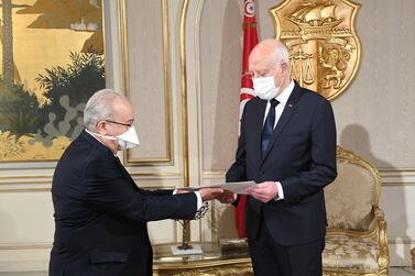 A handout picture provided by the Tunisian Presidency's official Facebook Page on August 23, 2021 shows President Kais Saied (R) receiving a letter from Algerian Minister of Foreign Affairs Ramtane Lamamra in the capital Tunis.  (Photo by -  /  various sources  /  AFP)  /  === RESTRICTED TO EDITORIAL USE - MANDATORY CREDIT "AFP PHOTO  /  HO  /  PRESIDENCY PRESS SERVICE " - NO MARKETING NO ADVERTISING CAMPAIGNS - DISTRIBUTED AS A SERVICE TO CLIENTS ===