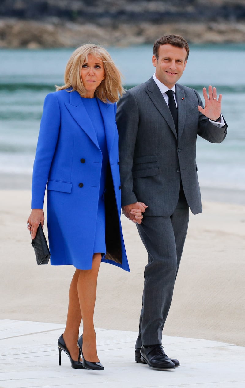 Brigitte, wearing a cobalt blue shift dress with a matching coat, visits Cornwall on June 11, 2021. AFP