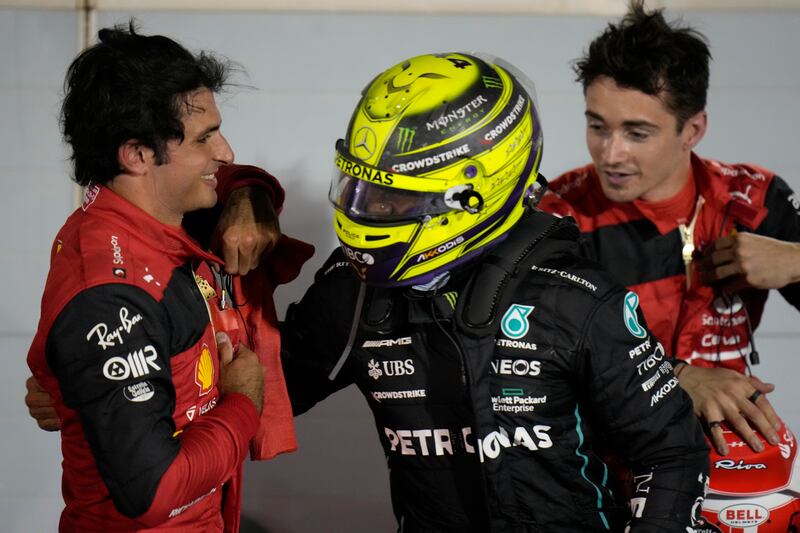Mercedes driver Lewis Hamilton greets Ferrari drivers Carlos Sainz of Spain, left, and race winner Charles Leclerc. AP