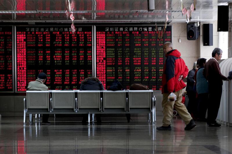 Investors monitor stock prices at a brokerage house in Beijing, Friday, Jan. 18, 2019. Chinese stocks rose Friday on signs of possible progress in negotiations over Beijing's tariff war with Washington. (AP Photo/Andy Wong)