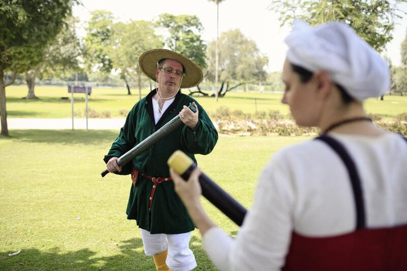 Mike Labny aka Earik, left, and Deborah Knight aka Rhona check their practice swords in Safa Park in Dubai.