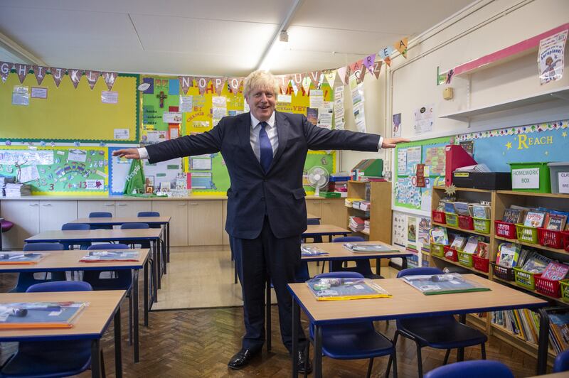 Mr Johnson demonstrating the two-metre distancing rule during his visit to St Joseph's Catholic Primary School in Upminster, East London, in August 2020. PA