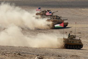 A Jordanian APC and US tanks take part in the "Eager Lion" multinational military manuever, in the Al-Zarqa governorate, some 85km northeast of the Jordanian capital Amman, on September 14, 2022.  - The United States, Jordan, and 28 partner nations are taking part in the multinational military exercise, from September 4 to 15, 2022, representing one of the largest military exercises in the region, and designed to exchange military expertise and improve interoperability among partner nations.  (Photo by Khalil MAZRAAWI  /  AFP)