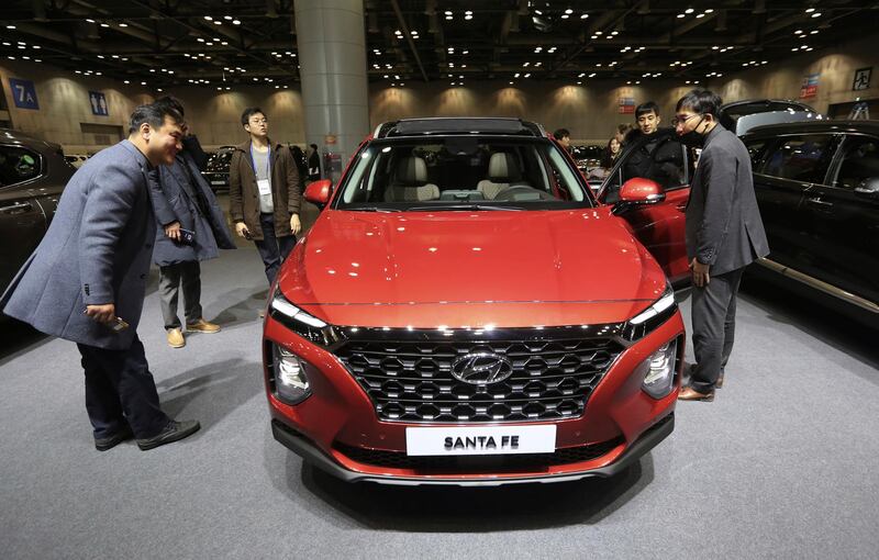 Members of the media view Hyundai Motor's all-new Santa Fe sport utility vehicle during a press unveiling at KINTEX exhibition center in Goyang, South Korea, Wednesday, Feb. 21, 2018. The vehicle is priced from 29 million won to 37 million won (US$27,260 - 34,780). (AP Photo/Ahn Young-joon)