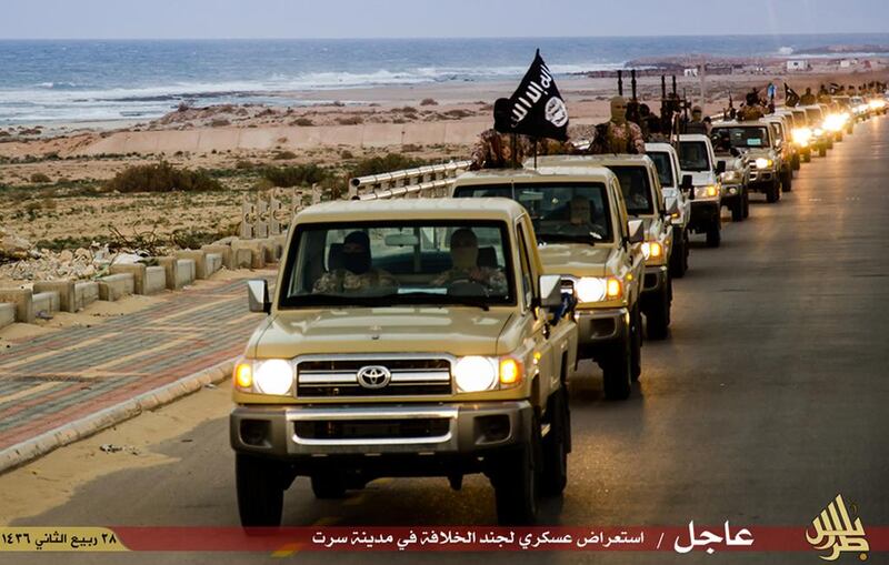 An image made available by the propagandist militant media outlet Welayat Tarablos on February 18, 2015, allegedly shows ISIL militants parading through Sirte. Welayat Tarablos/AFP Photo