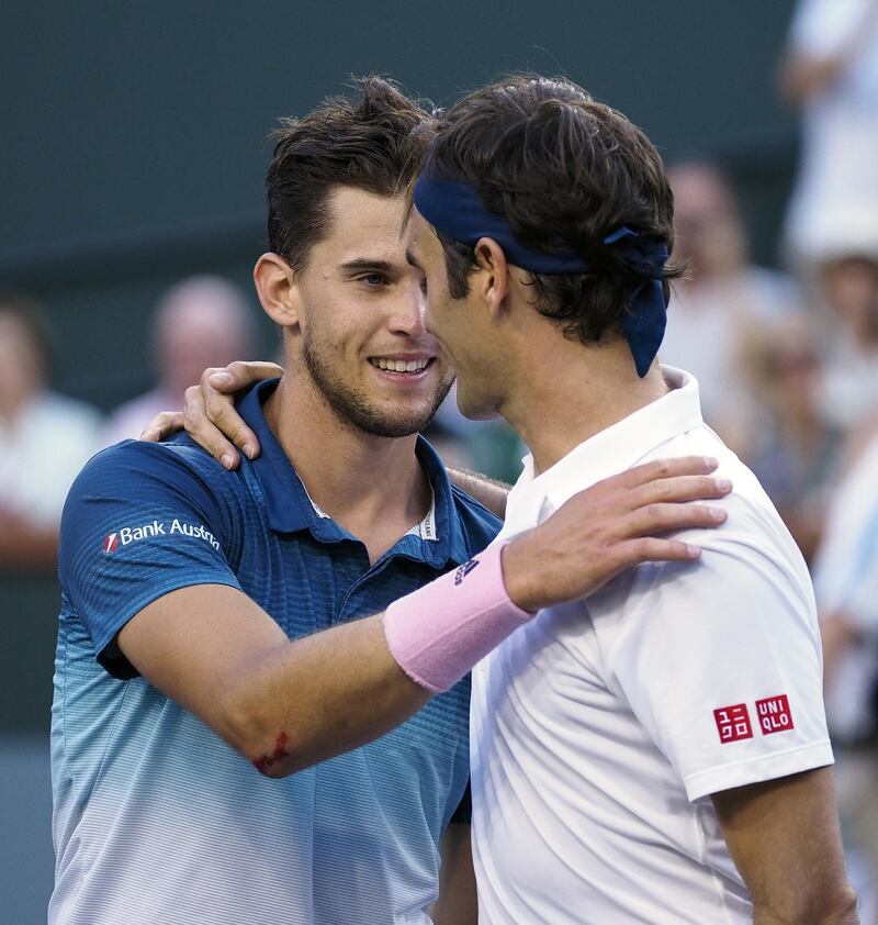 Dominic Thiem is greeted at the net by Roger Federer, who came in to the tournament in hot form. EPA