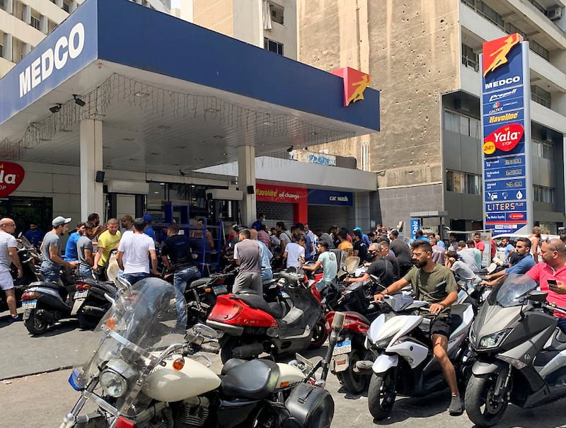Motorbike drivers wait to get fuel at a gas station in Beirut.