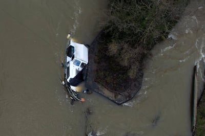 A sunken boat on the Thames in Oxfordshire, as Britain reels from the aftermath of Storm Henk. AP