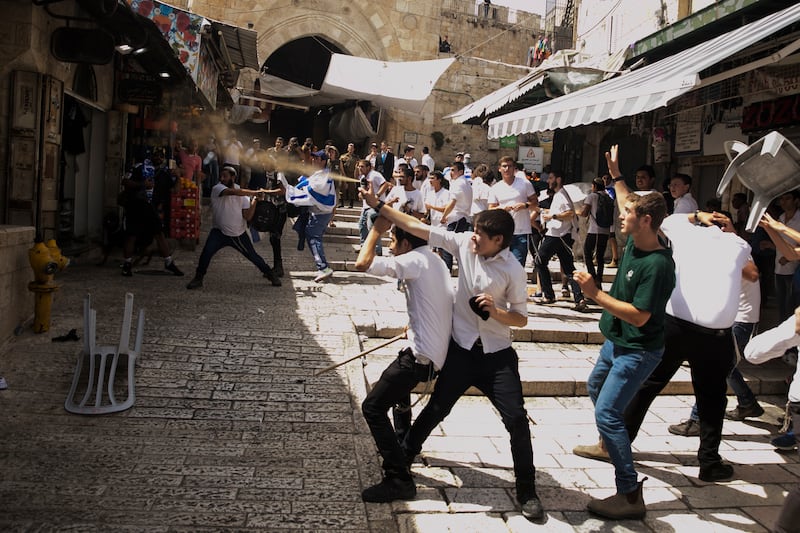 A Jewish youth uses pepper spray on Palestinians as they clash on the Muslim Quarter on Jerusalem Day in Israel. Getty 