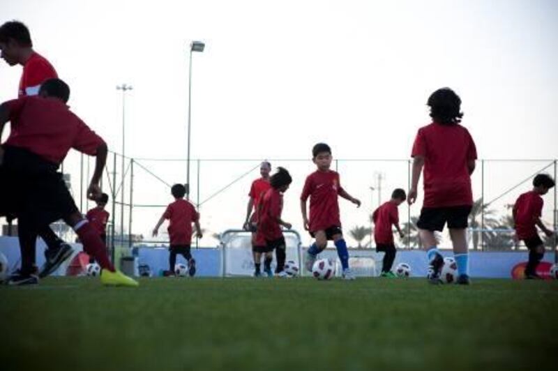 October 31, 2010, Abu Dhabi, UAE:

Children practice on a pitch next to the Dome on airport road during Manchester United School's first open session. The football club has opened up a training school to help young footballers hone in their skills. 

The common thread of the children is their love of the game, which has inspired them to take up this training course on top of their responsibilities at school.

Lee Hoagland/ The National




Lee Hoagland/ The National